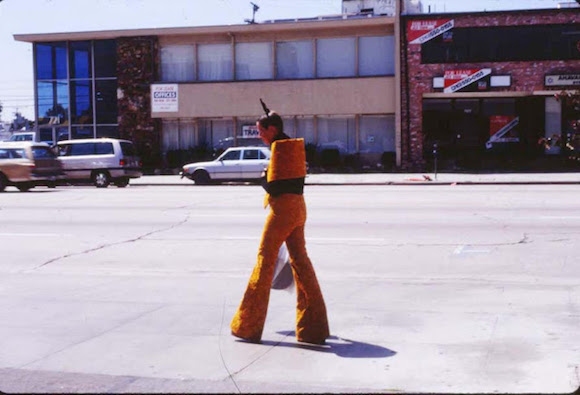 Woman walking along La Brea Boulevard, Los Angeles